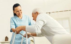 caregiver helping a senior man