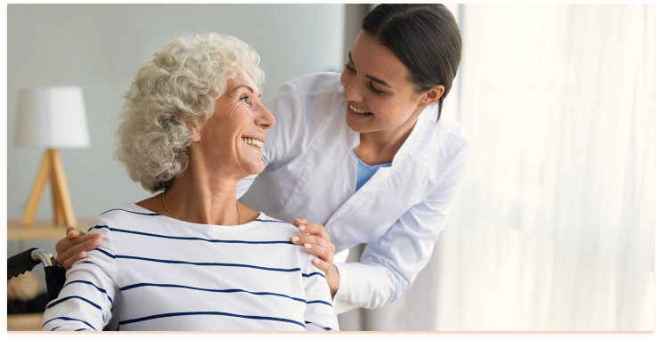 caregiver smiling to a senior woman