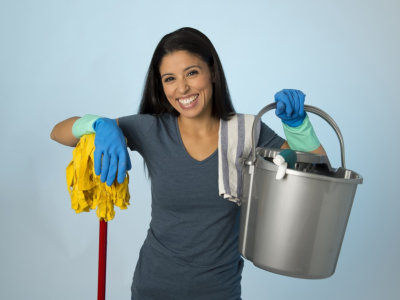 housekeeper holding the cleaning stuff