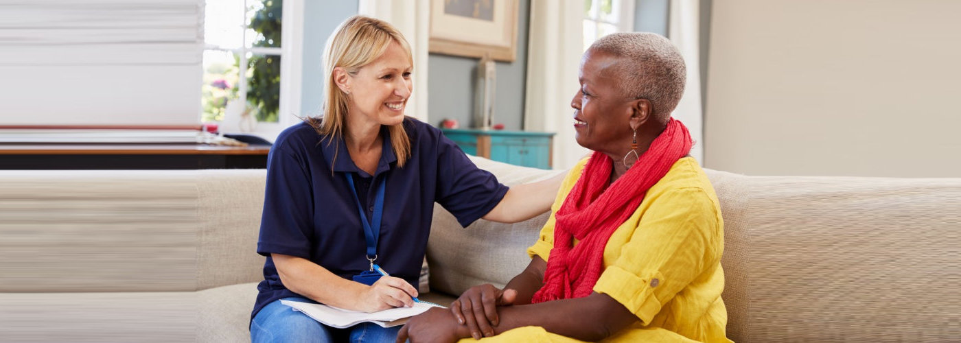 caregiver having conversation with a senior woman